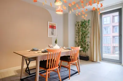 a dining room with a wooden table and chairs at New Inn Hotel Cadde 54 Mall in Sakarya