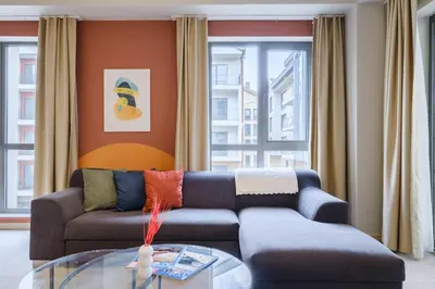 a living room with a couch and a glass table at New Inn Hotel Cadde 54 Mall in Sakarya