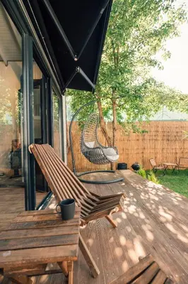 a wooden deck with a bench and an umbrella at Lemoon House Sapanca in Sapanca