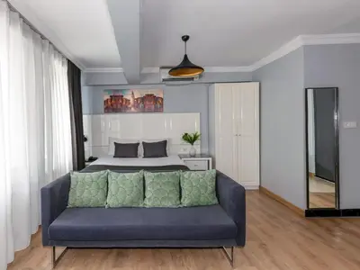 a living room with a couch and a bed at Lavanta Hotel in Istanbul