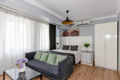 a bedroom with a bed and a couch in a room at Lavanta Hotel in Istanbul
