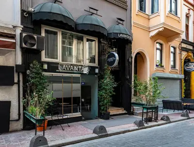 a store on a street with benches in front of it at Lavanta Hotel in Istanbul