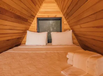 a bed in a wooden room with a window at Sapanca Casamia Suit in Sapanca