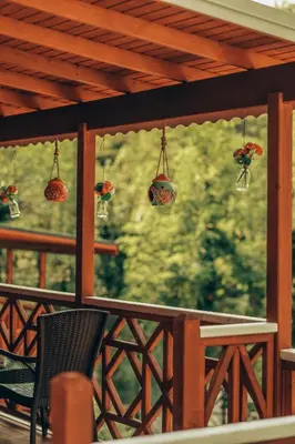 a porch with chairs and potted plants and a window at Sapanca Casamia Suit in Sapanca