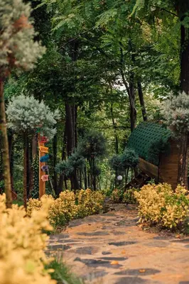 a garden with a bench and flowers and trees at Sapanca Casamia Suit in Sapanca
