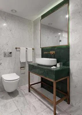 a bathroom with a sink and a toilet and a mirror at Pera Rasso Hotel in Istanbul