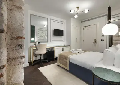 a bedroom with a bed and a desk and a chair at Pera Rasso Hotel in Istanbul