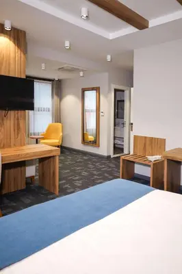 a hotel room with a large bed and a desk at ERTA SOYAK THERMAL OTEL in Çekirge