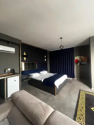 a bedroom with two beds and a couch in it at 216 Hill Suites in Istanbul