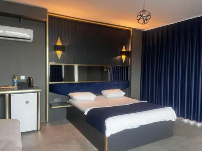 a bedroom with a bed with a blue head board at 216 Hill Suites in Istanbul