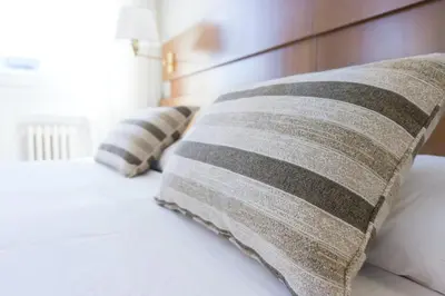 two pillows on a bed with a wooden headboard at Princely Suites Nişantaşı in Istanbul