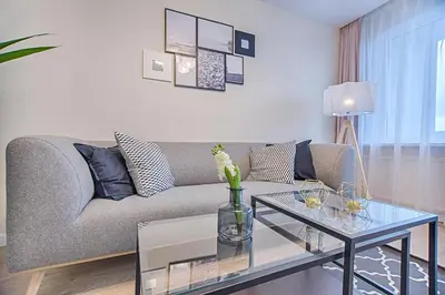 a living room with a couch and a glass table at Princely Suites Nişantaşı in Istanbul