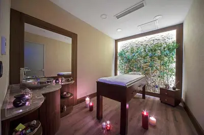 a bathroom with a tub and a window with candles at Dosso Dossi Hotels Old City in Istanbul