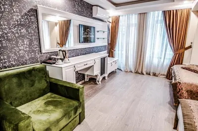 a living room with a desk and a green couch at Lazz City Hotel in Istanbul