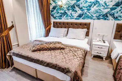 a small bedroom with a bed with a bed sqor at Lazz City Hotel in Istanbul