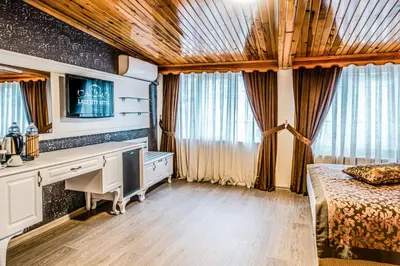 a bedroom with a desk and a bed and a television at Lazz City Hotel in Istanbul