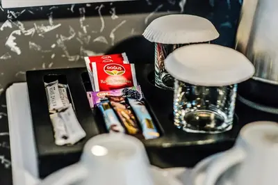 a table with toothbrushes toothpaste and a glass at Lazz City Hotel in Istanbul