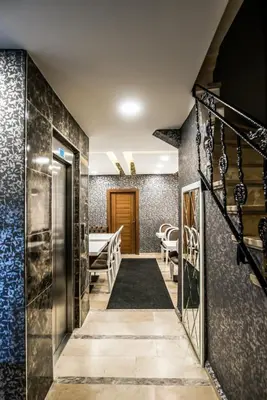 a hallway leading to a room with black and blue tiles at Lazz City Hotel in Istanbul
