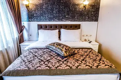 a bed with a pillow on it in a room at Lazz City Hotel in Istanbul