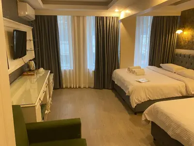a hotel room with two beds and a television at Lazz City Hotel in Istanbul