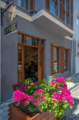 a store with pink flowers in front of a building at Lynda Hotel in Istanbul