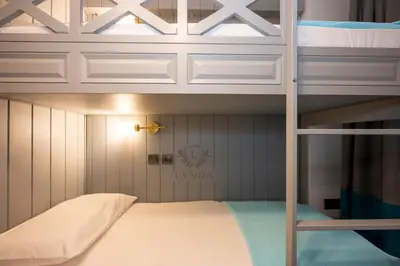 a bedroom with a bunk bed with a ladder at Lynda Hotel in Istanbul