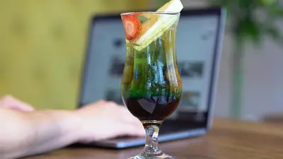 a drink with a slice of fruit in a glass at Homey AirPort Hotel in Arnavutköy