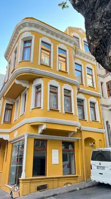 a yellow building with a white car parked in front of it at Mar Suite in Istanbul