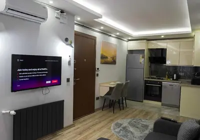 a living room with a tv on a wall at Mar Suite in Istanbul