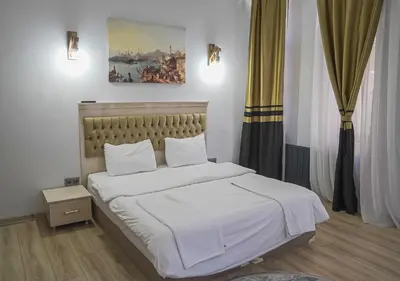 a bedroom with a bed with white sheets at Mar Suite in Istanbul
