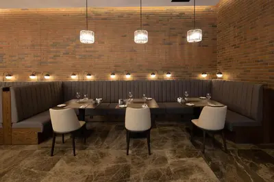 a restaurant with a long table with chairs and lights at Dedeman Kartepe Kocaeli in Kocaeli