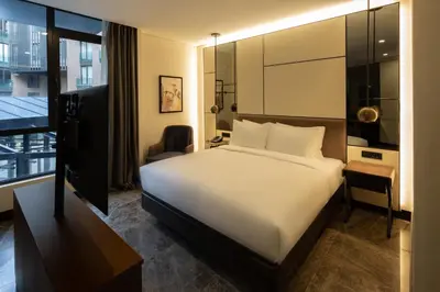 a hotel room with a large bed and a desk at Dedeman Kartepe Kocaeli in Kocaeli