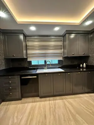 a kitchen with black cabinets and a sink and a window at SAPANCA ALHARRAN VILLA in Sapanca