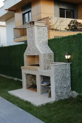 a stone fireplace in front of a house at SAPANCA ALHARRAN VILLA in Sapanca