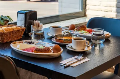 a table with plates of food on top of it at Görükle Alpaş Yaşam Hotel in Bursa