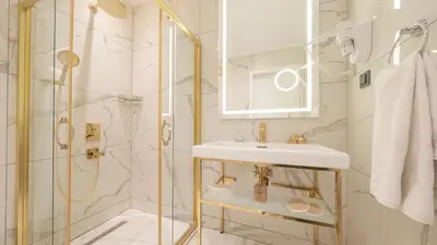 a white bathroom with a sink and a shower at Loop Hotel Bosphorus İstanbul in Istanbul