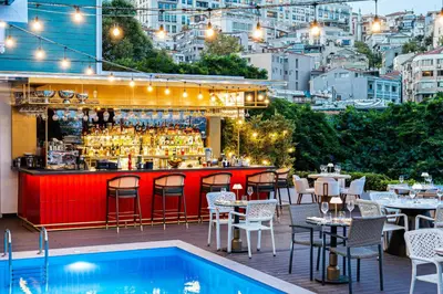 a bar with tables and chairs next to a pool at Loop Hotel Bosphorus İstanbul in Istanbul
