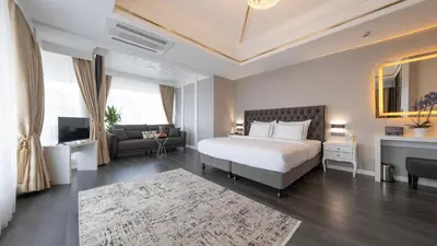 a bedroom with a bed and a couch and a television at Loop Hotel Bosphorus İstanbul in Istanbul
