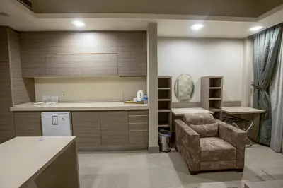 a kitchen with a couch and a chair in a room at Sen Otel in Sakarya