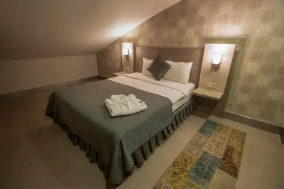 a bedroom with a bed with a towel on it at Sen Otel in Sakarya