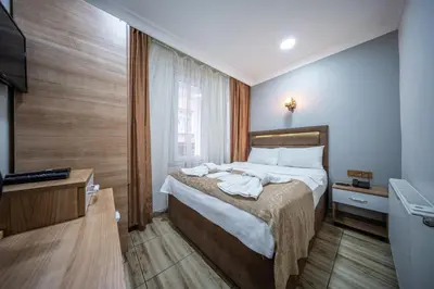 a hotel room with a bed and a television at LAOS OTEL in Istanbul