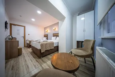 a hotel room with two beds and a table at LAOS OTEL in Istanbul