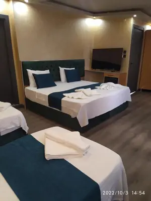 a hotel room with two beds and a flat screen tv at THE MOSS Hotel in Istanbul