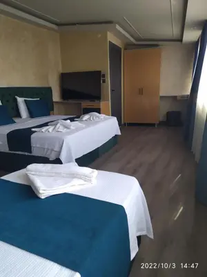 a hotel room with two beds and a tv at THE MOSS Hotel in Istanbul
