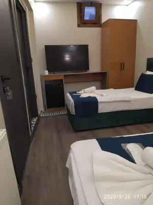 a hotel room with two beds and a flat screen tv at THE MOSS Hotel in Istanbul