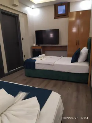 a hotel room with two beds and a flat screen tv at THE MOSS Hotel in Istanbul