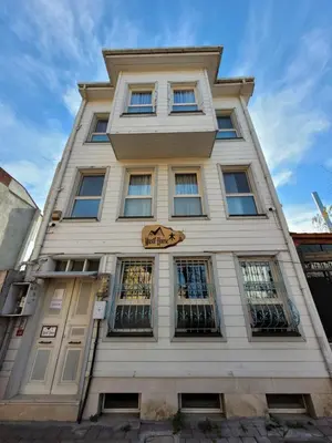 a tall white building with a cat sign on it at Masif House in Istanbul