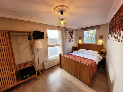 a bedroom with a large bed and a window at Masif House in Istanbul