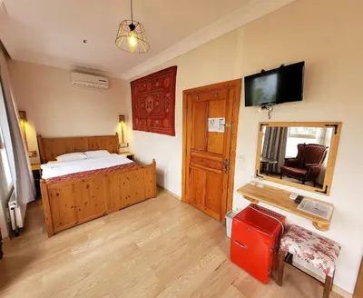 a bedroom with a bed and a mirror and a television at Masif House in Istanbul