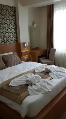 a hotel room with a bed with clothes on it at Istanbul Central Hotel in Istanbul